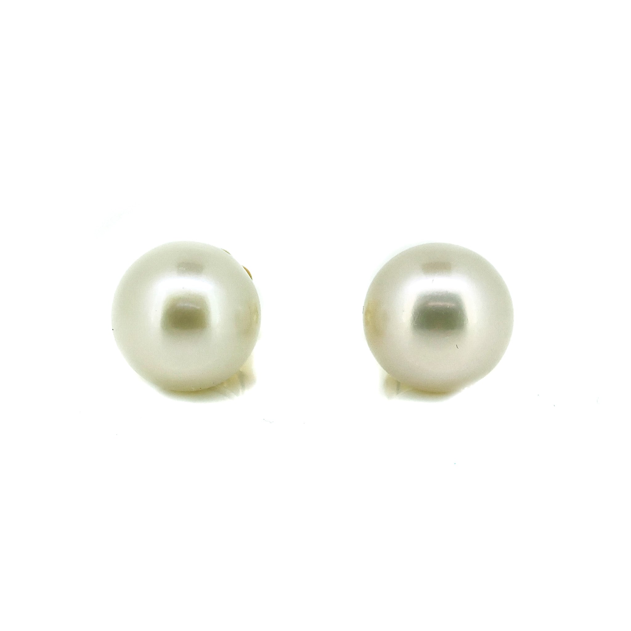bold white pearl studs set in gold