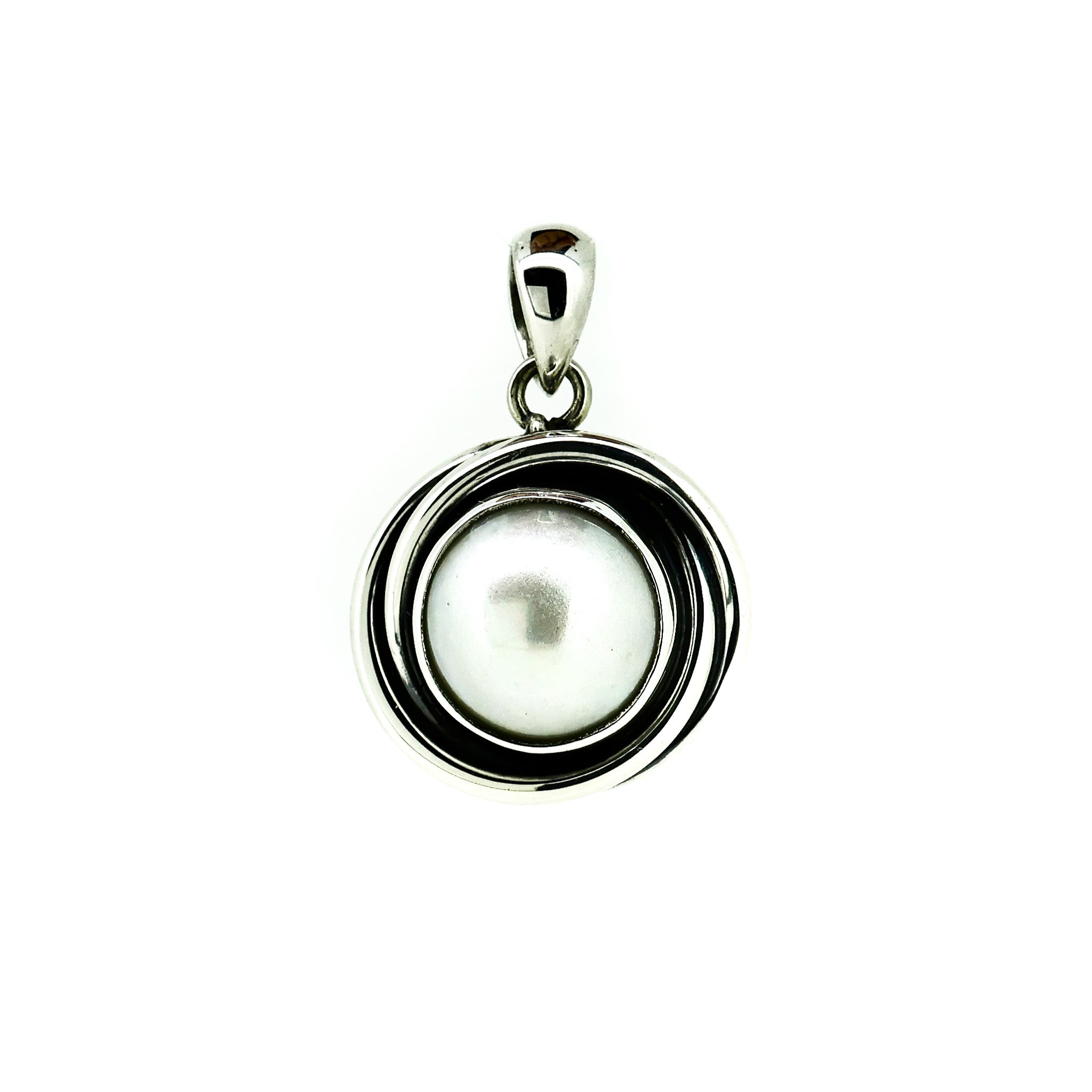 silver pendant with central pearl with swirls of silver reminscent of a sunset