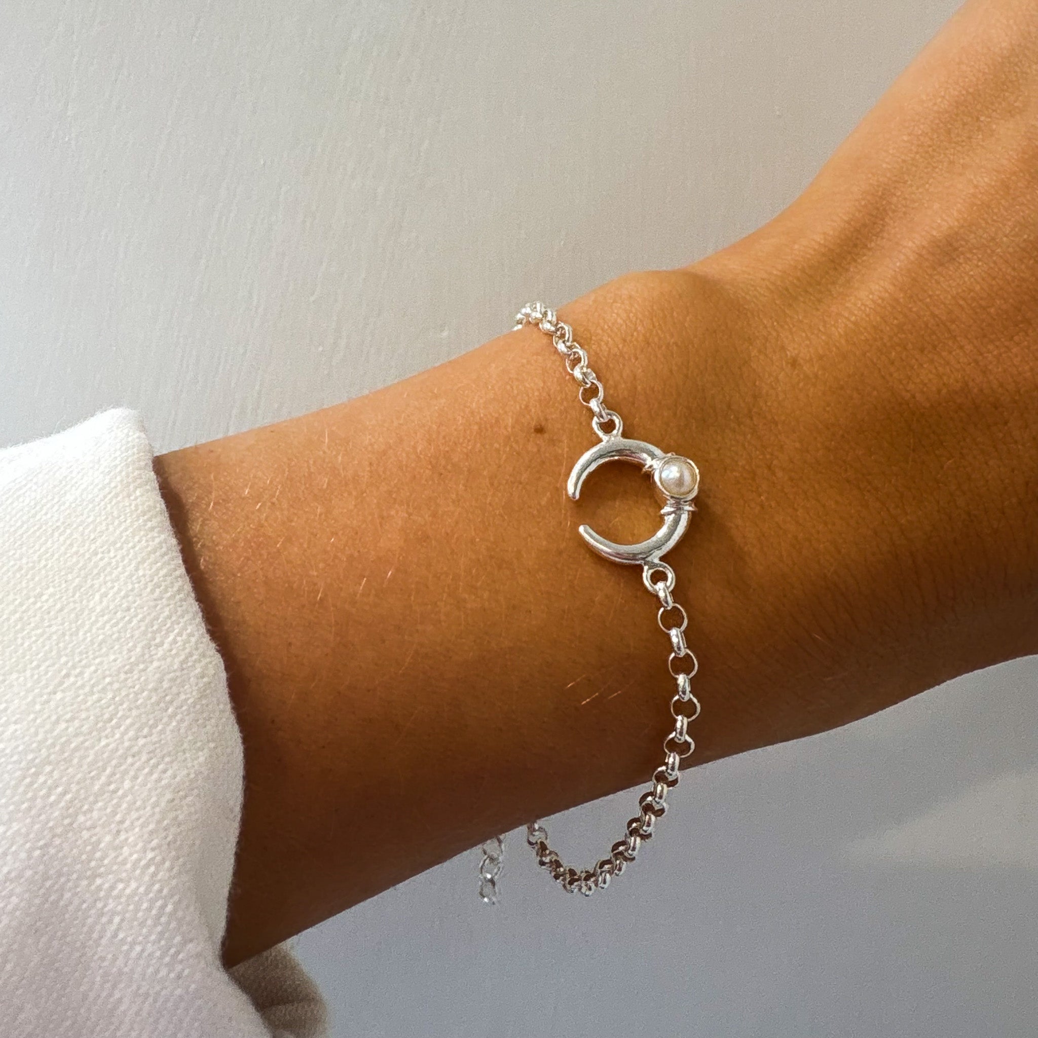silver bracelet with a crescent shaped moon