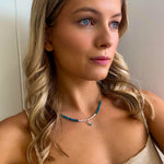 dainty necklace with dainty pearls and blue gemstones