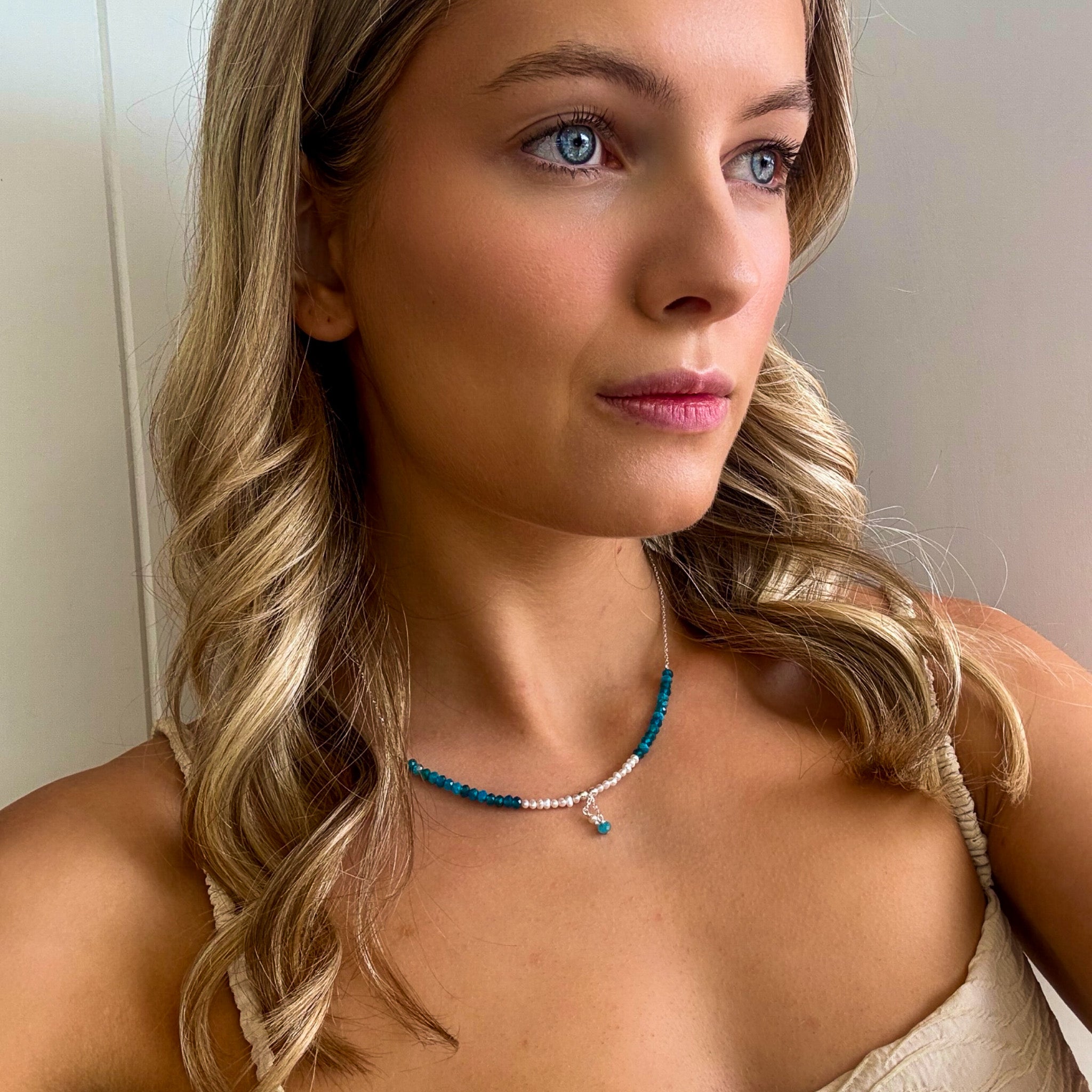 dainty necklace with dainty pearls and blue gemstones