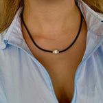 pearl necklace on black neoprene