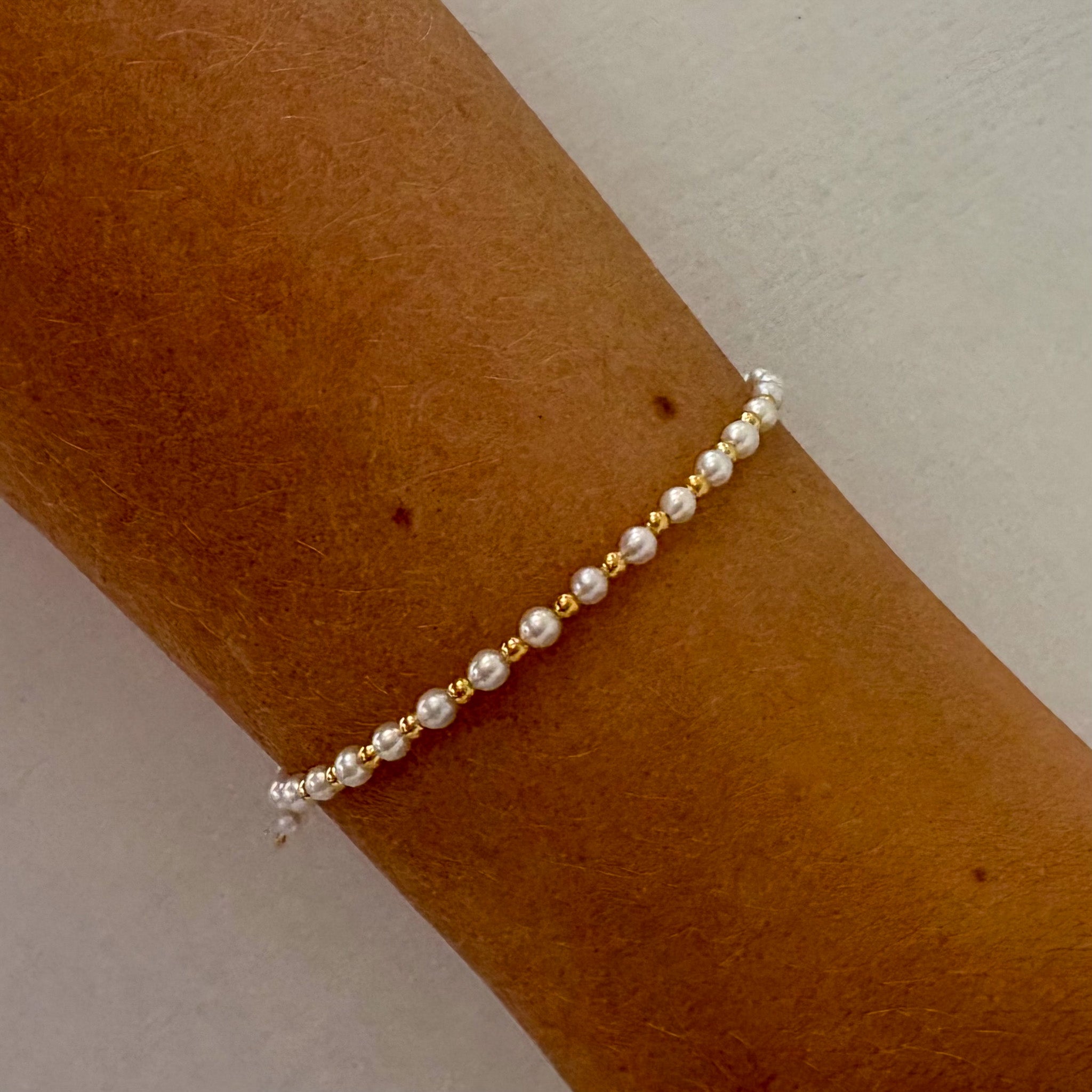 dainty pearl and gold bead bracelet