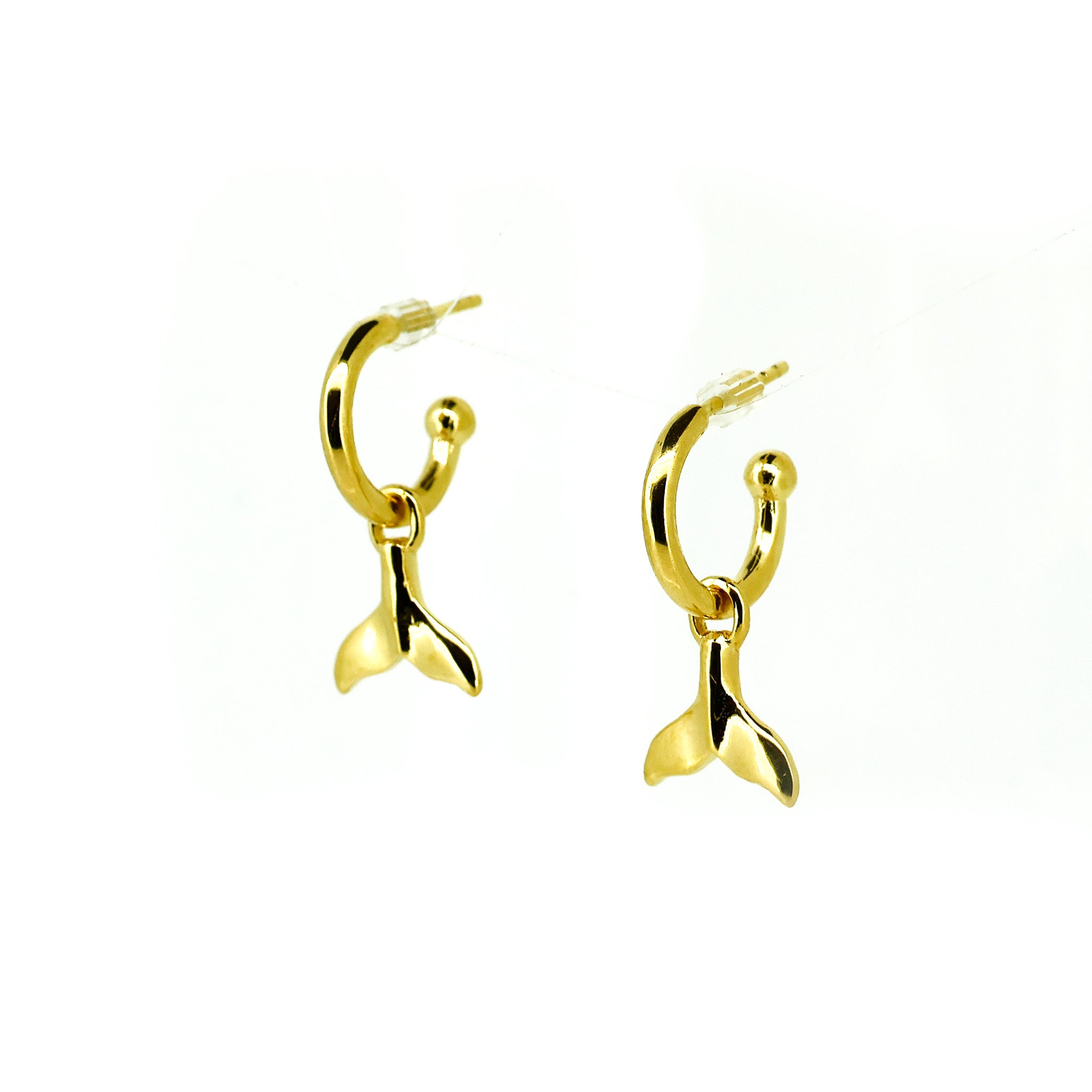 gold huggie earrings with whale tail charm