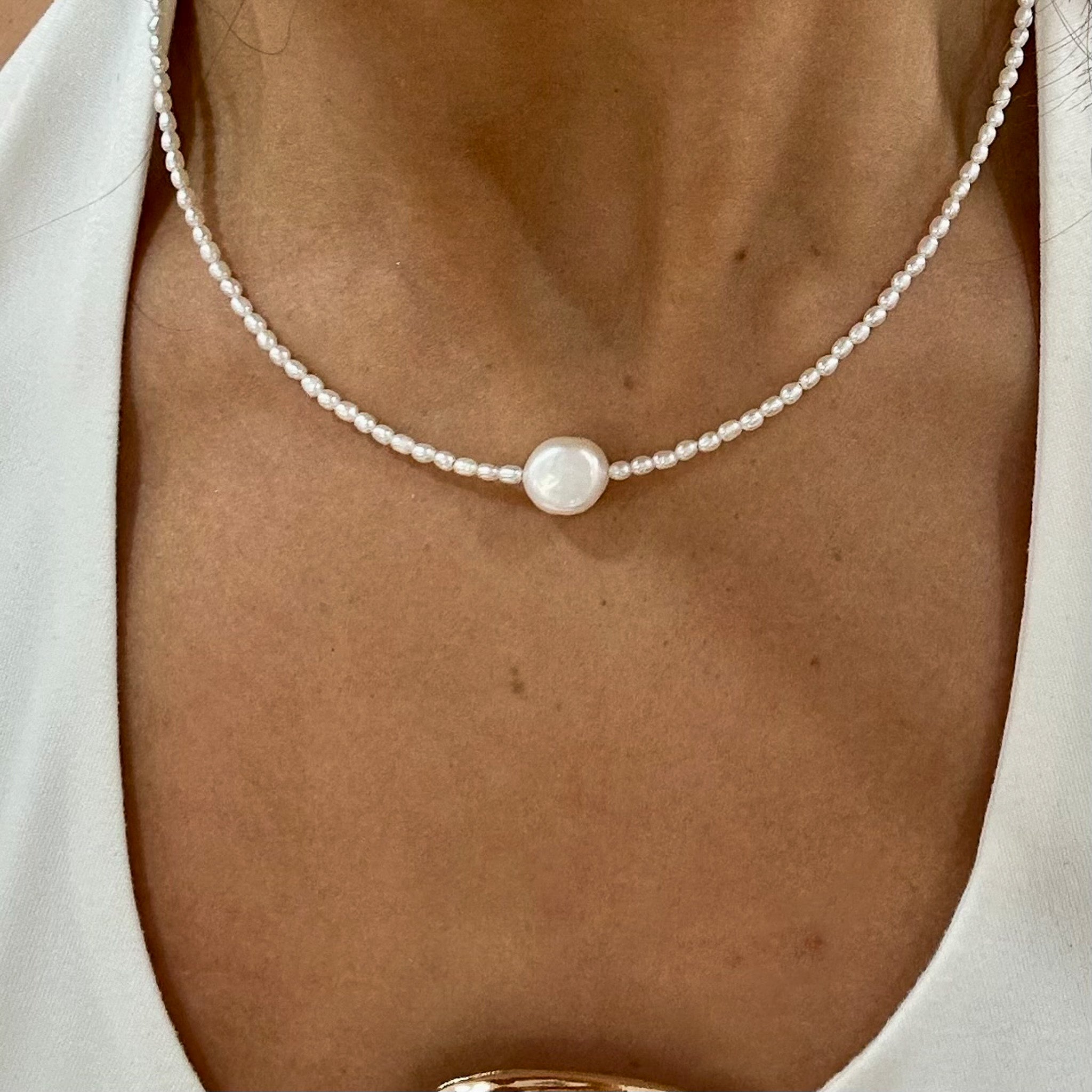 dianty pearl necklace with one central freshwater pearl