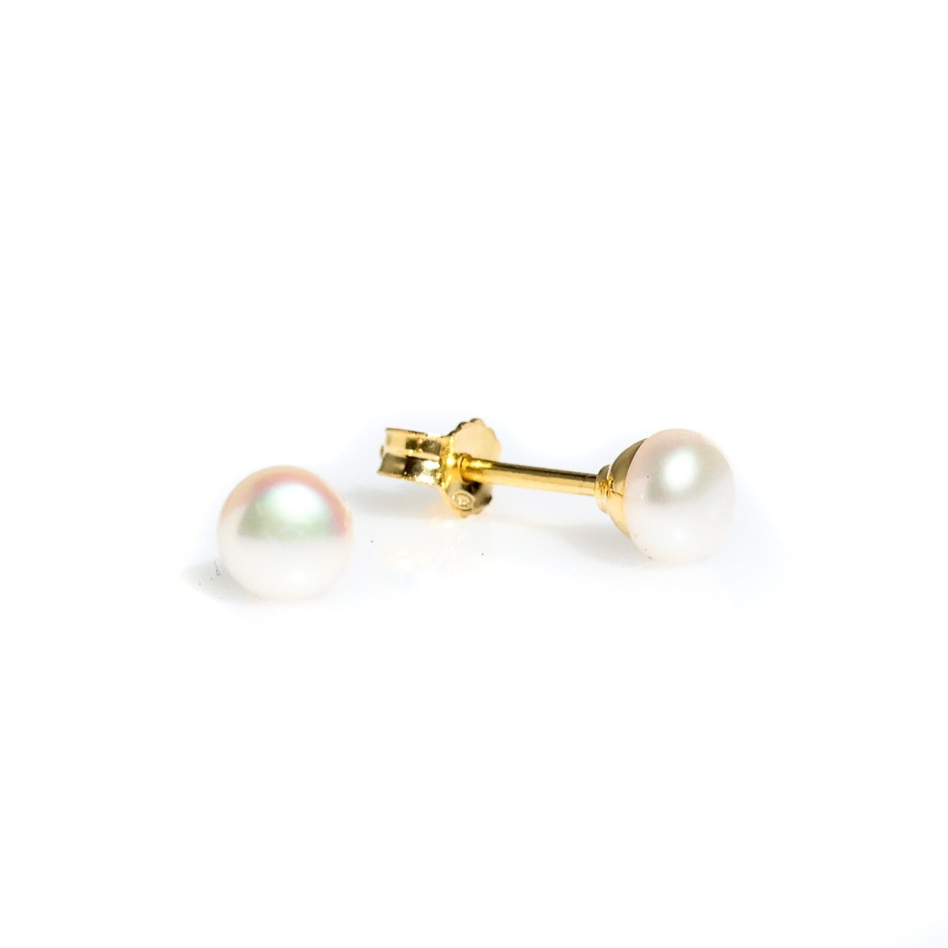 white pearl studs set in gold